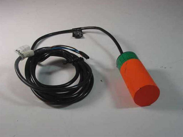 Efector KB-3020-BPKG inductive proximity sensor switch — full view showing orange cylindrical housing with green collar and attached black cable coiled