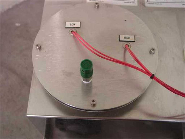Top panel of tank lid showing LOW and HIGH level indicator labels, green indicator light, and red sensor wiring