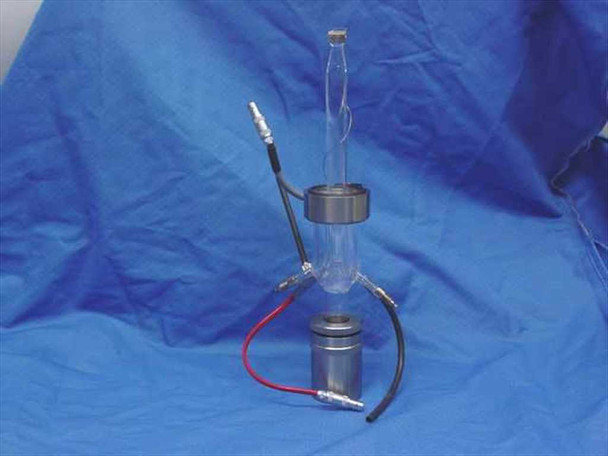TMA quartz sample holder full assembly against blue fabric background — showing complete glass tube, stainless steel base, and all lead wires