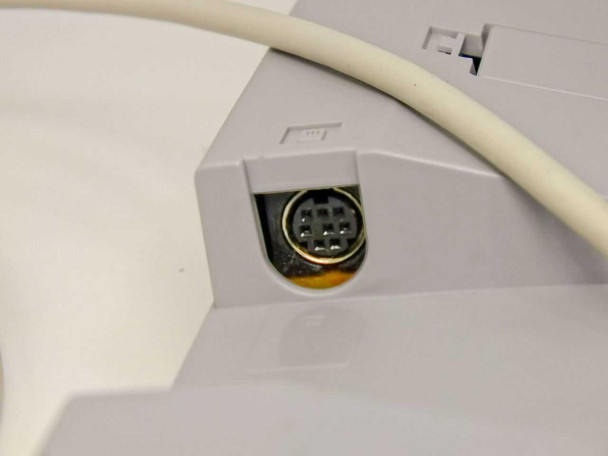 Close-up of Sun Type 5c keyboard cable exit point and 8-pin Mini-DIN female socket on chassis underside