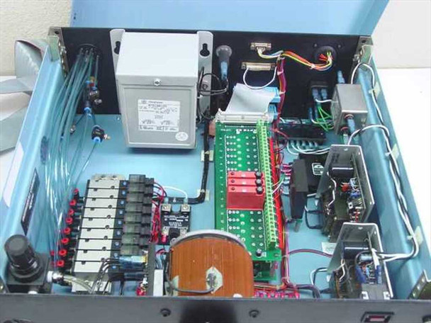 Interior of blue control enclosure showing Staco variac, SMC VZ2150 solenoid valve manifold, green Opto 22 terminal board, regulated power supply, wiring harness, and GE transformer