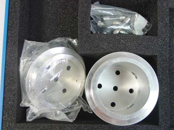Two machined aluminum disc components with mounting holes, one wrapped in plastic, alongside a hardware bag