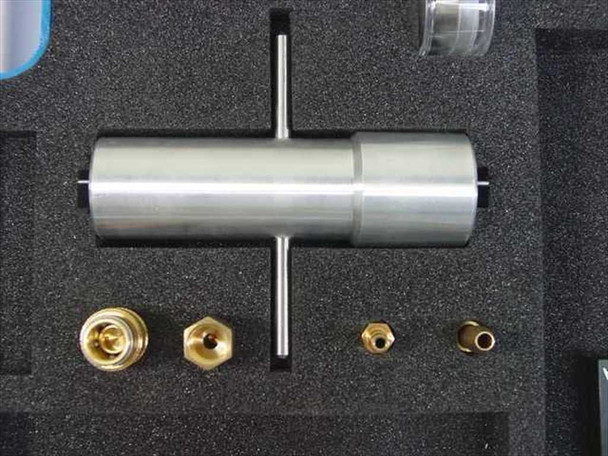 Stainless steel cylindrical T-handle tool and four brass fittings and adapters in foam cutouts