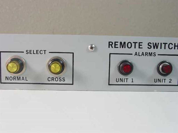 LNR Communications DC-P2 front panel close-up – Normal and Cross Select pushbuttons with yellow indicators, Unit 1 and Unit 2 Alarm indicators in red