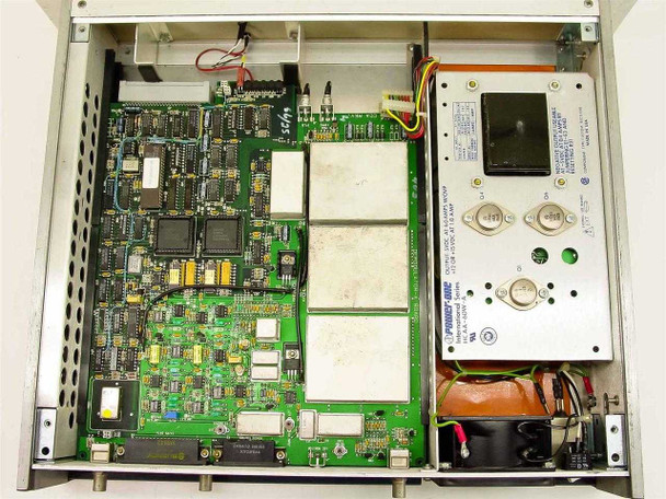 ComStream CM101 interior view — main PCB assemblies with multiple ICs and shielded RF modules, Power-One HCAA-60W-A internal power supply visible at right