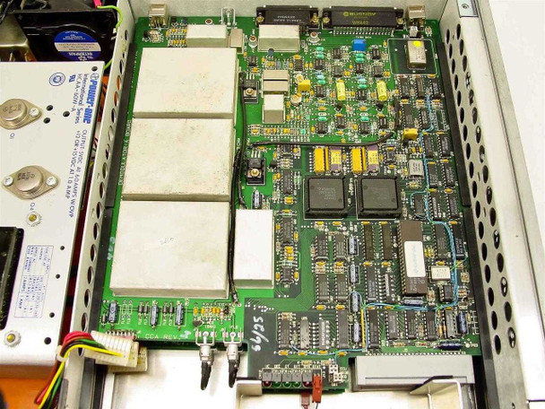 ComStream CM101 interior top-down view — main modem board with Motorola and other ICs visible, shielded RF subassemblies, and Power-One supply at left