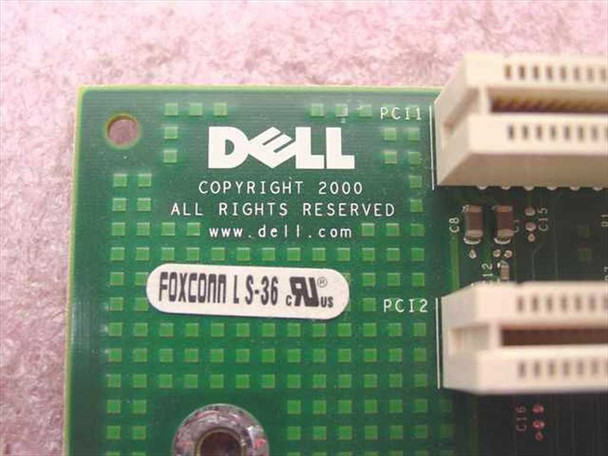 Dell 0583XT riser card close-up of Dell logo, Copyright 2000, and Foxconn LS-36 label with PCI1 and PCI2 slot labels