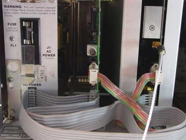 Interior rear view of Scientific Atlanta 7300 chassis showing AC power input label (115V/230V 50/60Hz), fuse holder (2.5A slow blow), DC power section, and internal ribbon cable harness