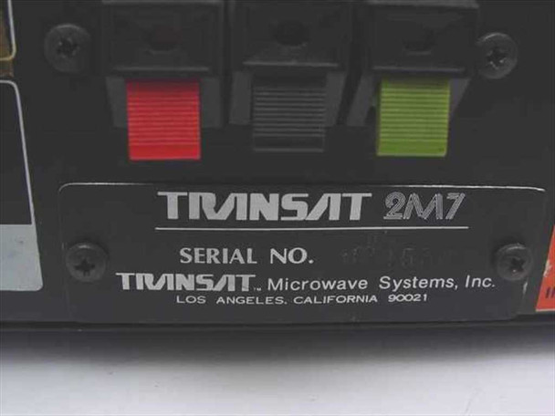 Transat 2M7 Satellite Receiver — rear label close-up showing TRANSAT 2M7 model designation, serial number plate, and Transat Microwave Systems Inc., Los Angeles California 90021 manufacturer identification