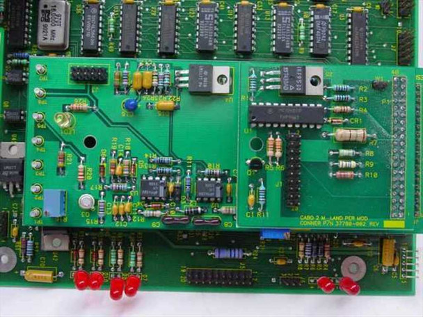 Close-up of secondary PCB labeled CABO 2M LAND PER MOD, CONNER P/N 37788-002 with red LED indicators and mixed DIP IC population