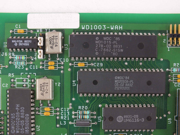 Close-up of WD1003-WAH PCB showing WDC WD1015-PL ROM chip, WD2010B-PL controller chip, and crystal oscillators near board edge