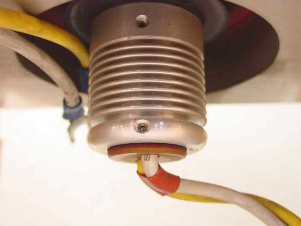 CPI VKC-7936 klystron tube gun/cathode assembly close-up — ribbed aluminum gun housing with color-coded lead wires (yellow, red, white) and ceramic insulator ring visible