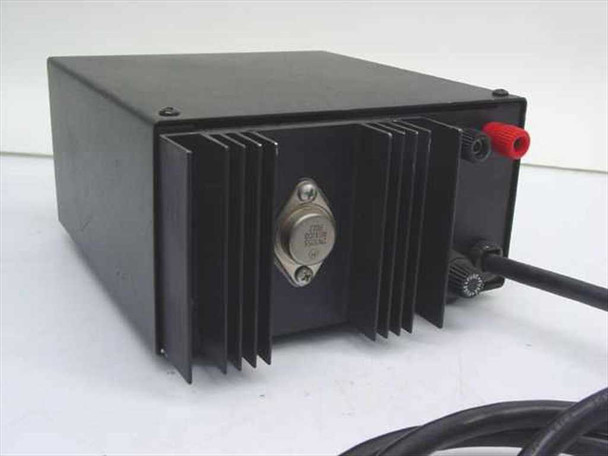 Unbranded 13.6V DC regulated power supply – rear/side view showing large passive heatsink with TO-3 transistor, red and black binding post output terminals, and attached AC power cord