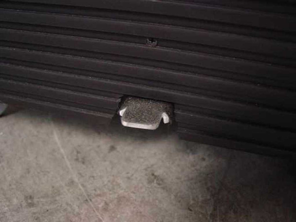 Close-up of Egan Visual S2PM cabinet foot pedal at base of end panel – used to raise and lower the projector platform