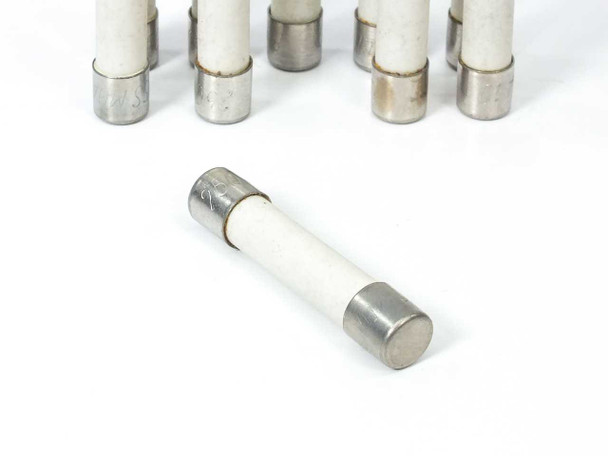 Fusetron MDA-10 ceramic fuse – single fuse lying flat in foreground with additional fuses standing in background