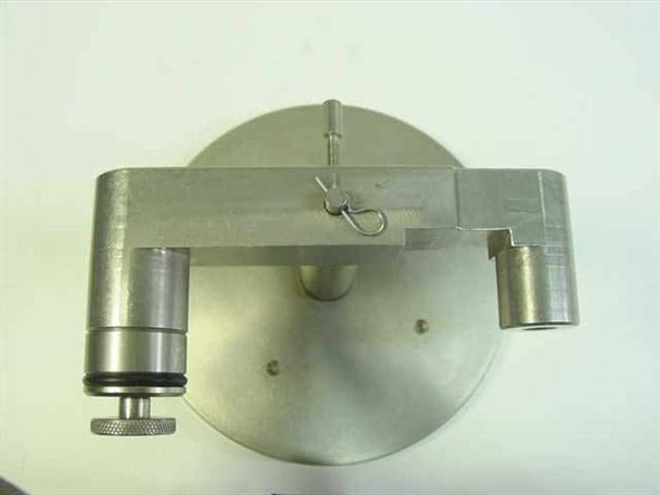 Underside of stainless steel weighted baseplate showing round disc with three mounting holes and cotter pin clip on arm assembly