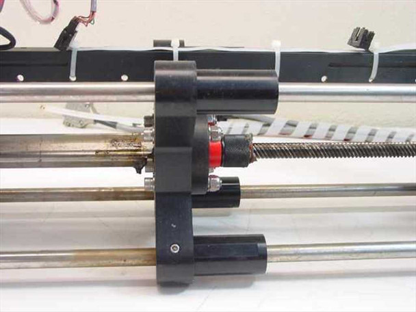 Mycom BRA85-10 center carriage close-up showing lead-screw nut, red bearing, and dual linear guide rails with wear