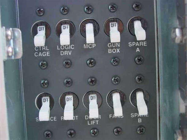 IVS Accuvision 200 – toggle switch panel showing OFF-position switches labeled Ctrl Cage, Logic Drv, MCP, Gun Box, Spare A, Service, Robot, Door/Lift, Fans, Spare B