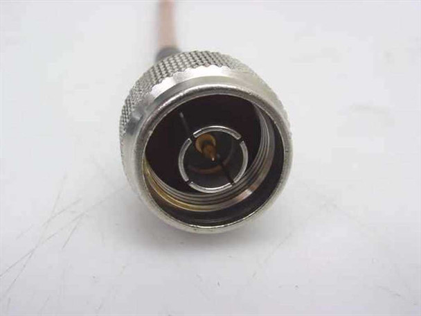 Close-up of N-Male connector end on ESM Cable Corp RG-142 coaxial cable showing center pin and knurled coupling nut