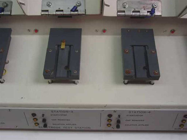 Elite Engineering Electrode Test Station — top view of Stations 3 and 4 with lids open showing electrode test fixtures; Station 3 has a gold contact element visible