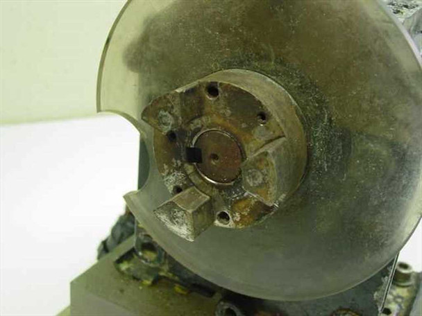 Close-up of Dayton 3M328A gear motor output shaft end showing corroded 3-slot coupling hub and clear plastic guard