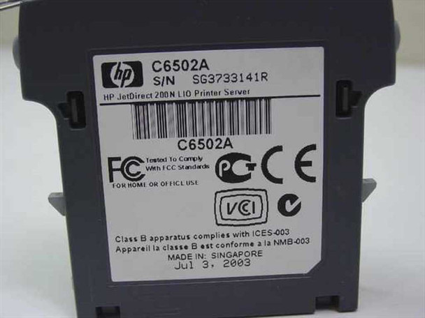 HP C6502A JetDirect 200N LIO Print Server – label showing model C6502A, serial number, manufacture date July 3 2003, Made in Singapore, FCC and CE markings
