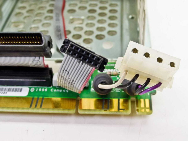 Compaq 199880-001 carrier board close-up showing 68-pin SCSI connector, power connector, and ribbon cable – 1996 date code visible