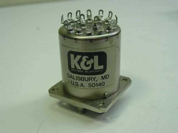 K&L Microwave 6MP-28-F-0-4 SP6T coaxial relay — top and side view showing cylindrical stainless body, K&L Microwave Incorporated label, Salisbury MD USA markings, and solder lug terminals on top