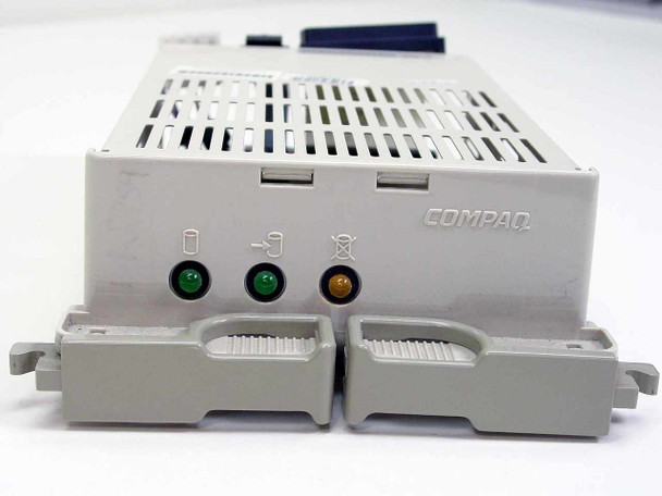 Compaq 199656-001 drive caddy — front face showing COMPAQ logo, three status LEDs (green, green, amber), and two release handles