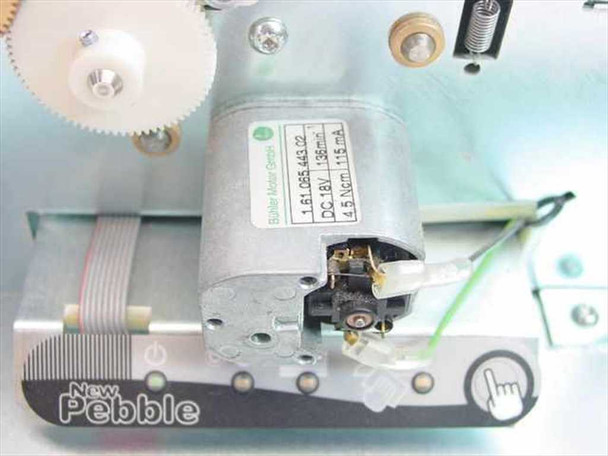 Close-up of internal stepper/DC motor assembly labeled DC 18V 136mA, 4.5 Ncm, 116mA, with New Pebble branding visible on front panel strip