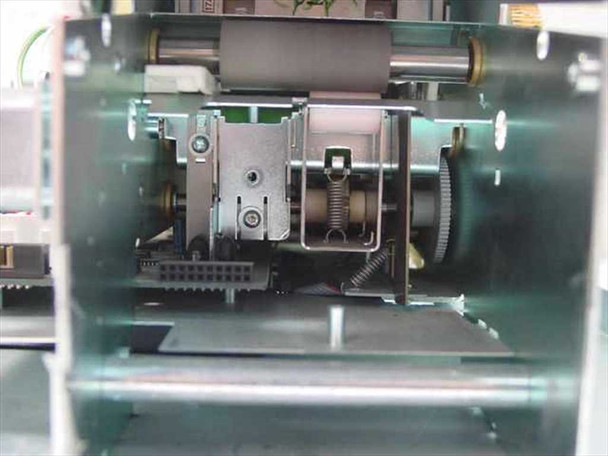 Interior close-up of Evolis Kiosk printhead carriage area — printhead mount visible with empty carriage (no printhead installed), spring mechanism, and drive gears
