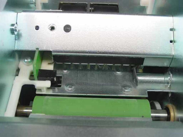 Evolis Kiosk internal close-up — empty printhead bay with green platen roller, printhead mounting bracket with three screw holes, and card transport mechanism