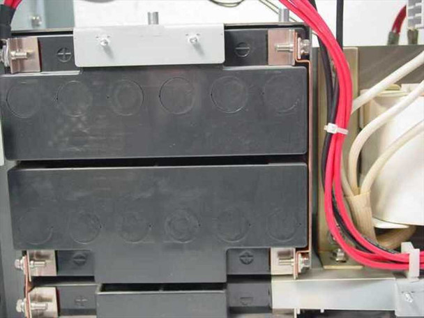 Minuteman PML2000 interior showing two battery cases stacked in battery compartment with red wiring harness and internal components visible