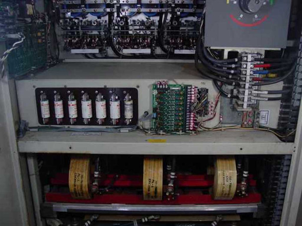 Emerson AP340 UPS – interior lower section showing six cylindrical fuses, control PCB, large toroidal transformers on red-painted shelf