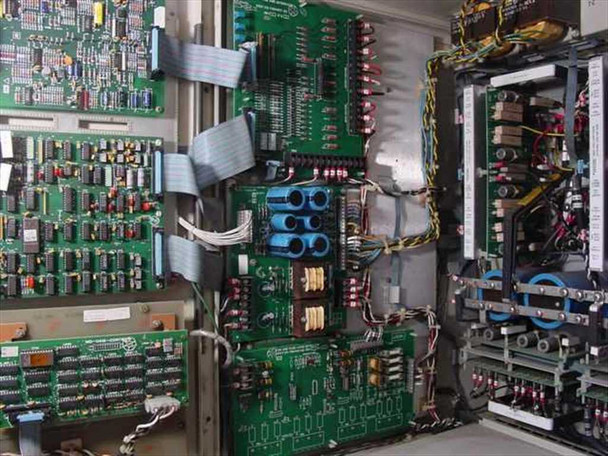 Emerson AP340 UPS – interior right side showing multiple populated PCBs, large capacitors, and terminal block wiring panel