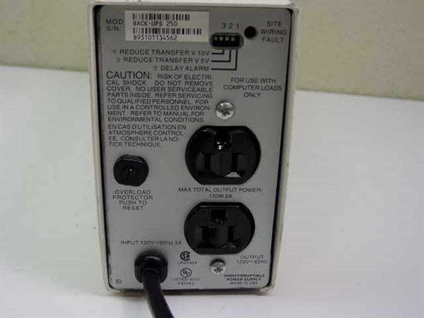 APC Back-UPS 250 rear panel close-up showing NEMA outlets, rating label with 120V 60Hz 170W 2A specs, overload protector button, and site wiring fault indicator