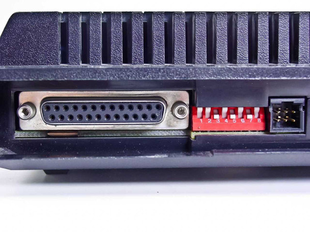 Microcom QX/12K rear panel close-up showing DB25 RS-232 serial port and red DIP switch bank