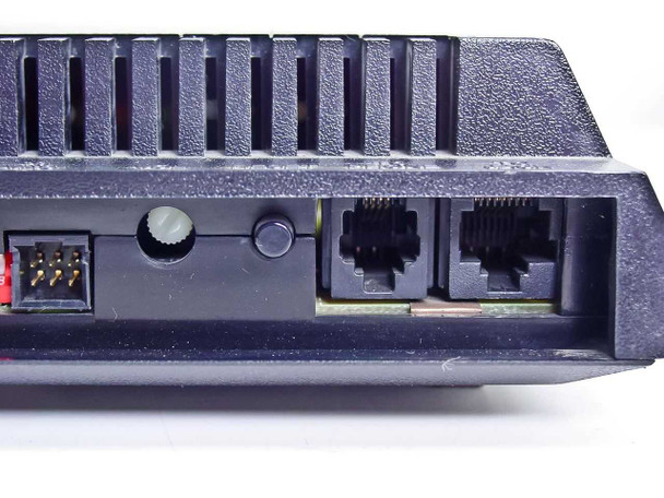 Microcom QX/12K rear panel close-up showing dual RJ-11 phone jacks, power connector, and volume control