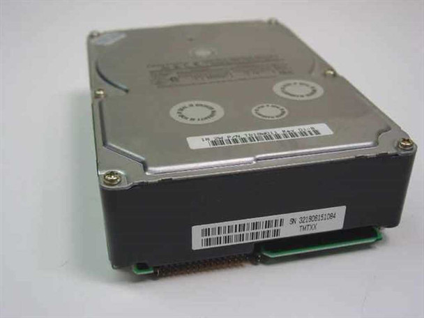 Quantum Atlas III 18.2GB 3.5-inch SCSI hard drive — angled top-right view showing drive top cover with warranty seals and barcode label with serial number