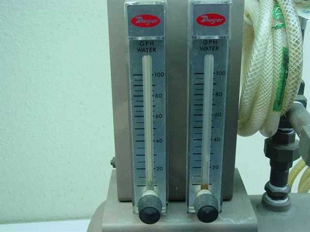 Close-up of dual Dwyer GPH Water flow meters on Brunner Engineering air station, scaled 0 to 100+ GPH with adjustment knobs