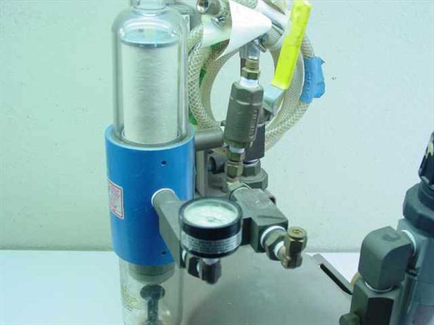 Close-up of water separator filter assembly and small pressure gauge with fittings and tubing connections on Brunner Engineering air station