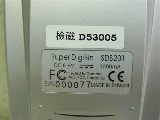 Close-up of Super DigiBin SDB201 rear label showing model SDB201, DC 8.6V 1200mA power rating, FCC compliance, CE mark, and serial number 000077