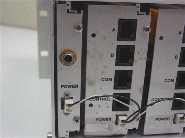 Rear panel detail showing power input connector and two Model 7006 switch modules with visible grime and discoloration on chassis