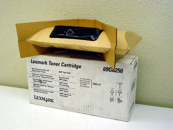 Lexmark 69G8256 toner cartridge in original open box showing sealed black inner bag – front of box with model number and Optra E compatibility visible