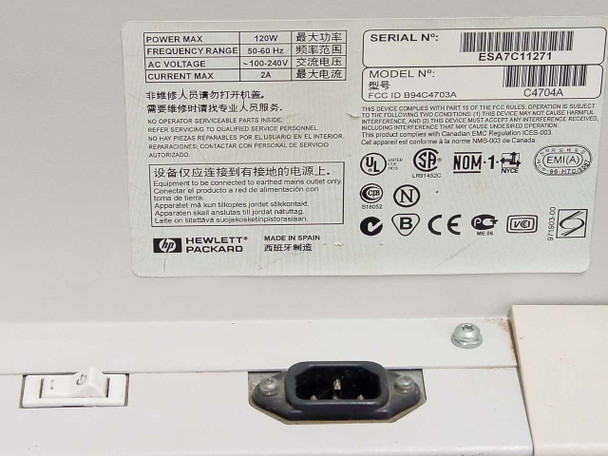 HP C4704A rear label showing power specs: 100-240V, 50-60Hz, 2A, 120W max, serial number, FCC ID, CE marks, Made in Spain