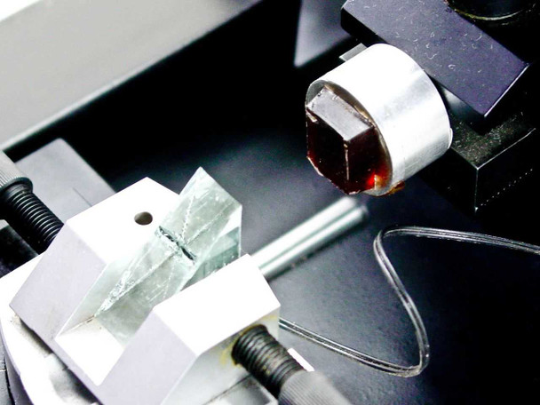 Reichert-Jung 2050 SuperCut knife and specimen block macro close-up — glass knife holder with embedded specimen block, fine positioning mechanism visible