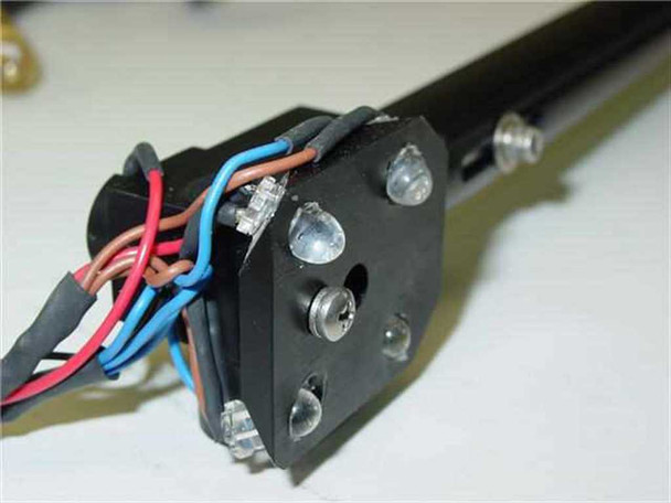 Close-up of optical tube tip showing LED illumination array with four LED emitters and wiring harness (red, blue, black wires)