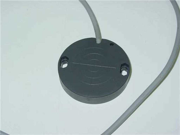 Pepperl+Fuchs CJ30-50K10-E2-Y capacitive proximity sensor – front sensing face view showing concentric ring pattern and two mounting holes