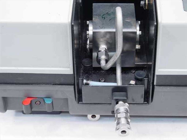 Pye Unicam 9423 sample compartment open view showing small custom vacuum chamber accessory with stainless fittings, tubing, and inlet/outlet ports