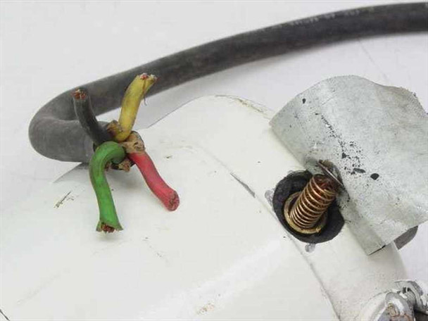 Close-up of power cable termination showing bare wire ends — yellow, green, red conductors — and mounting bracket detail with spring contact